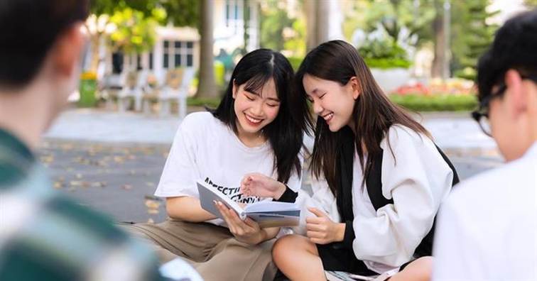 Two women sitting on a bench looking at a book

AI-generated content may be incorrect.